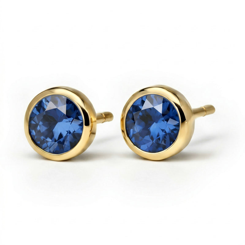 sapphire birthstone stud earrings in yellow gold finish — side view