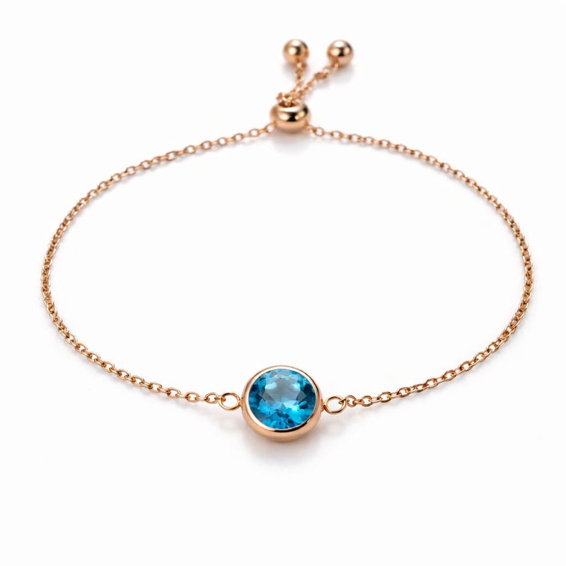 blue topaz birthstone bracelet in rose gold finish — front view