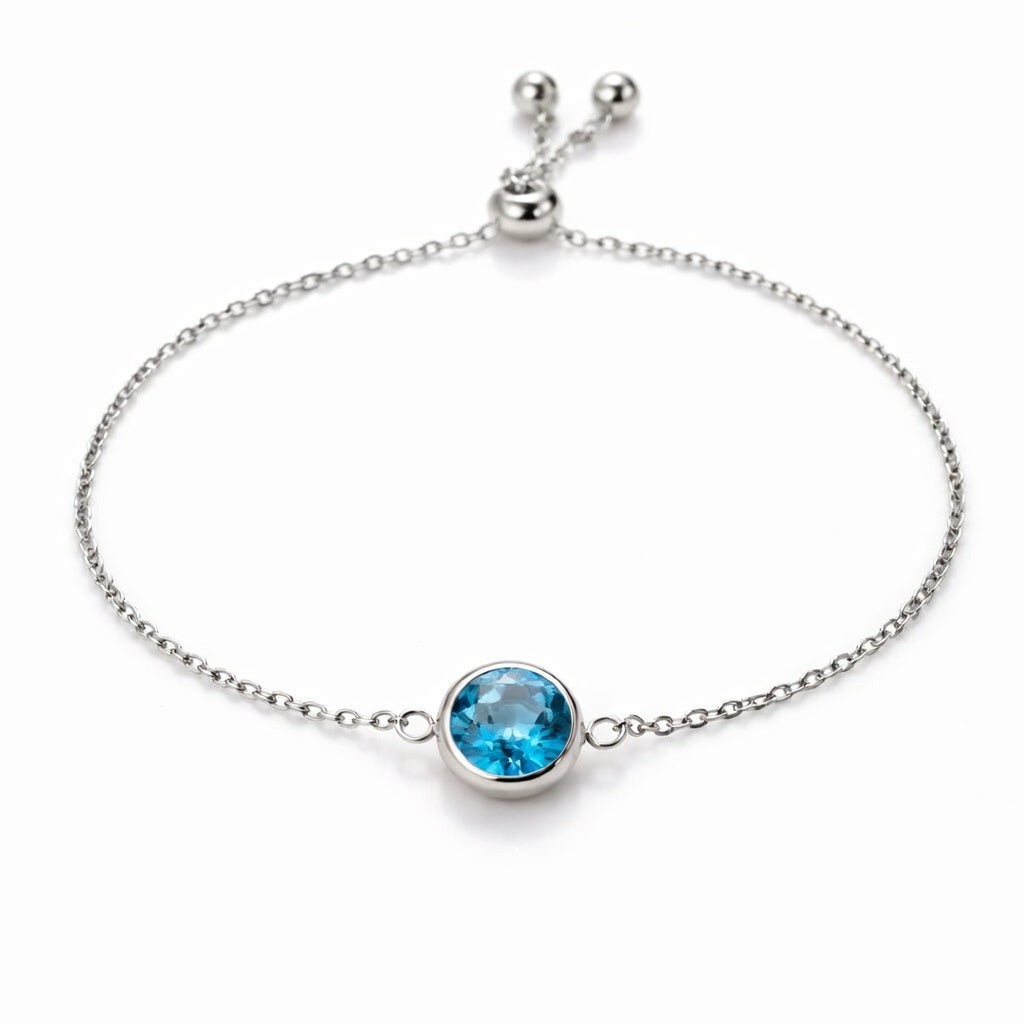 blue topaz birthstone bracelet in white gold finish — front view