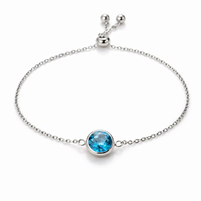 blue topaz birthstone bracelet in white gold finish — front view