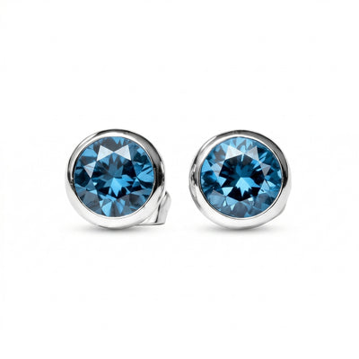 blue topaz birthstone stud earrings in white gold finish — front view