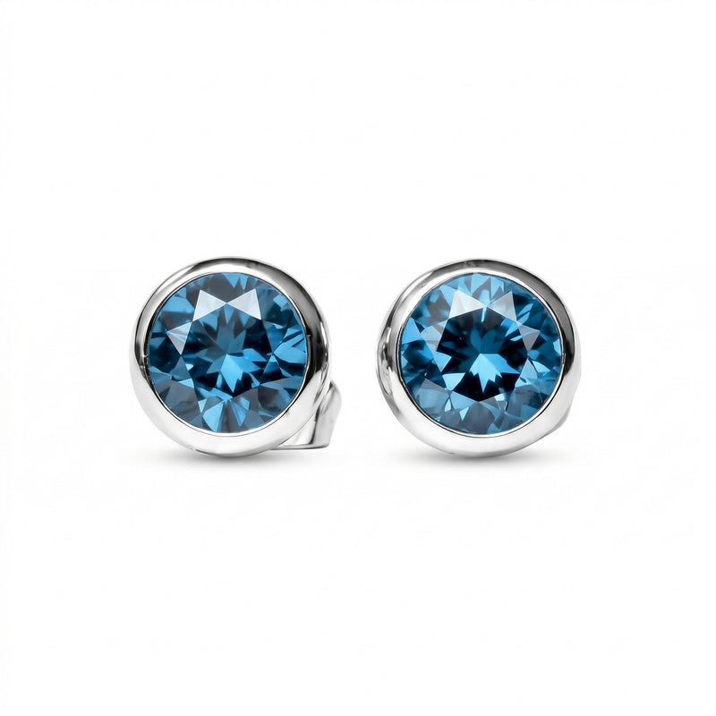 blue topaz birthstone stud earrings in white gold finish — front view