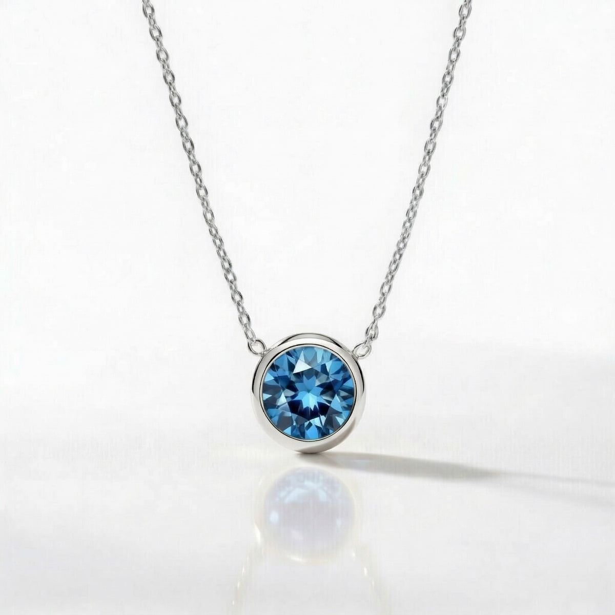 blue topaz birthstone necklace in white gold finish — front view