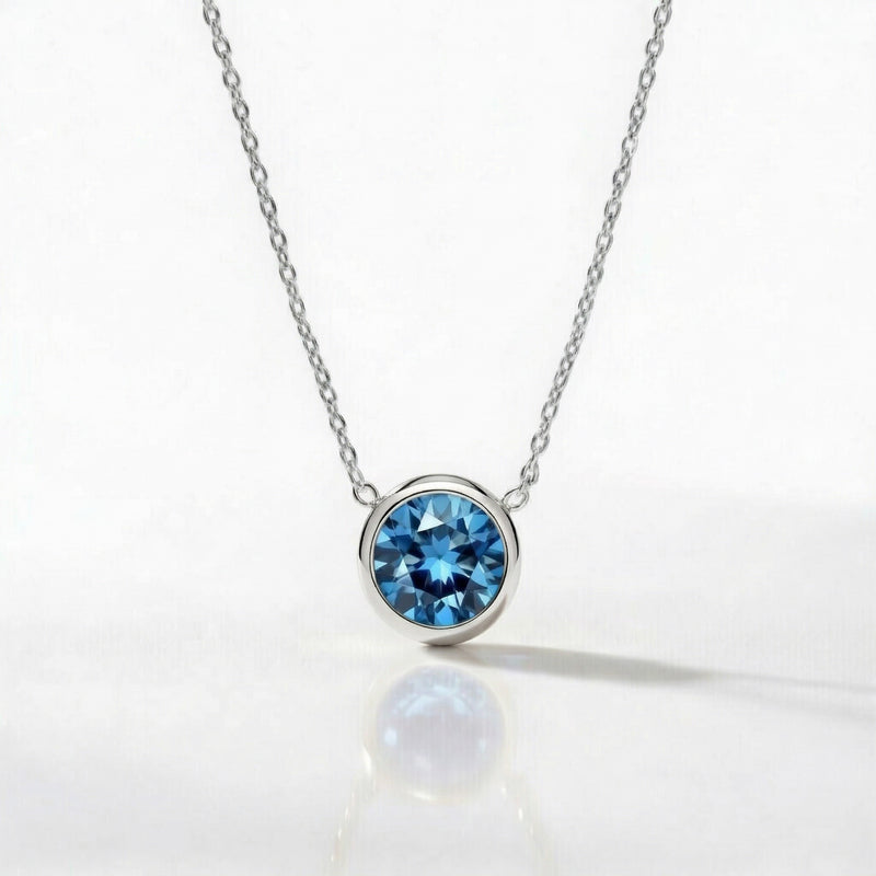blue topaz birthstone necklace in white gold finish — front view