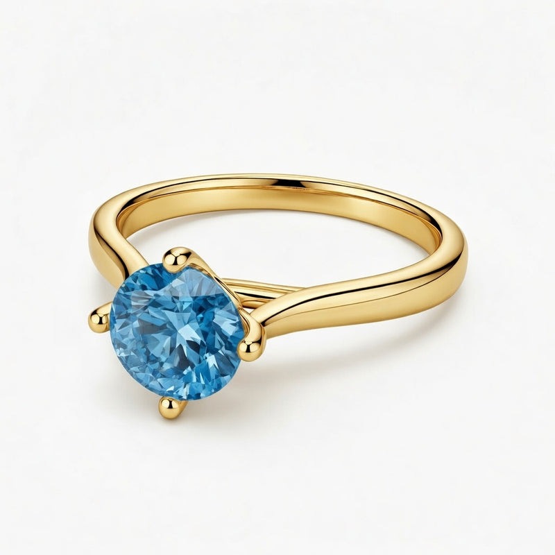 blue topaz birthstone ring in yellow gold finish — front view