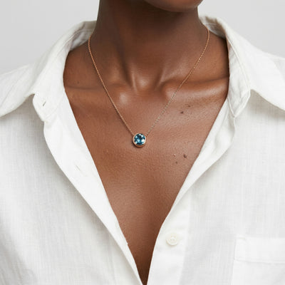 blue topaz birthstone necklace in rose gold finish — model view