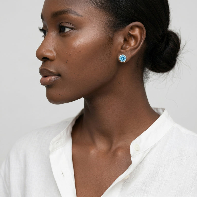 blue topaz birthstone stud earrings in white gold finish — model view