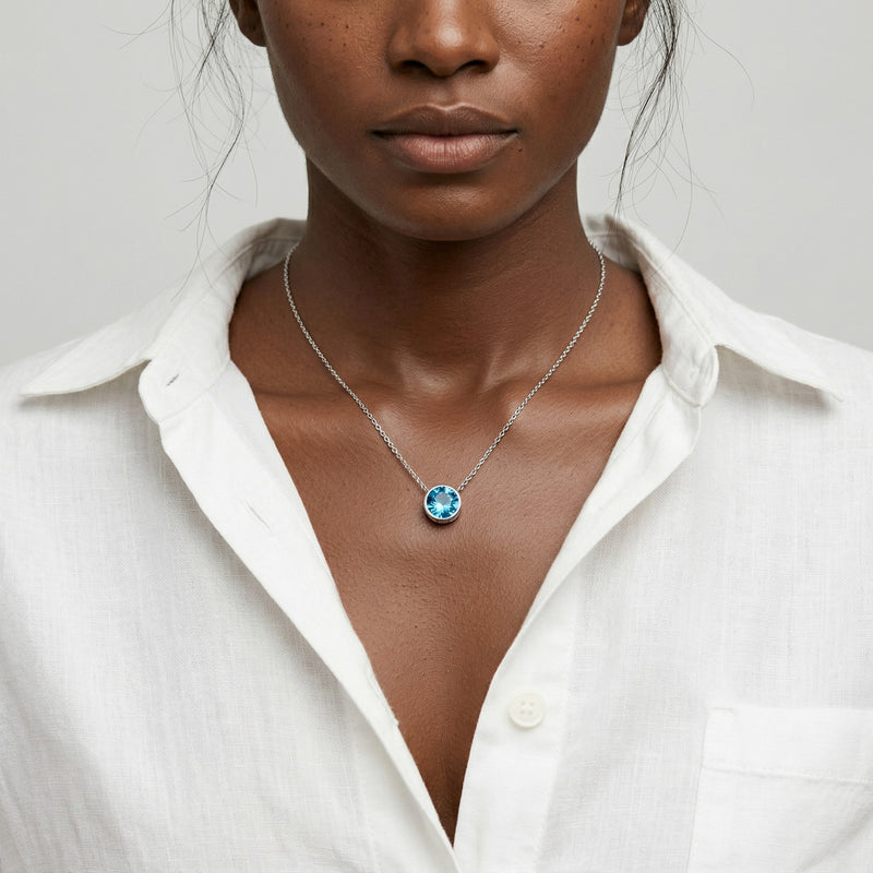 blue topaz birthstone necklace in white gold finish — model view