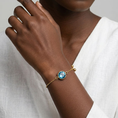 blue topaz birthstone bracelet in yellow gold finish — model view
