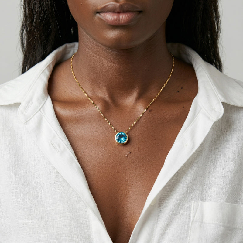 blue topaz birthstone necklace in yellow gold finish — model view