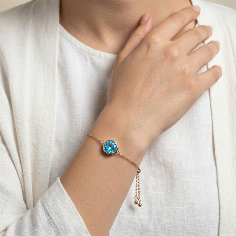 blue topaz birthstone bracelet in rose gold finish — model view