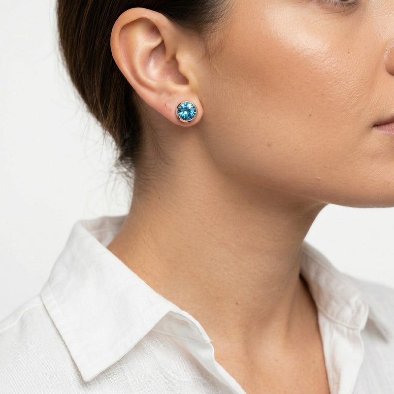 blue topaz birthstone stud earrings in rose gold finish — model view