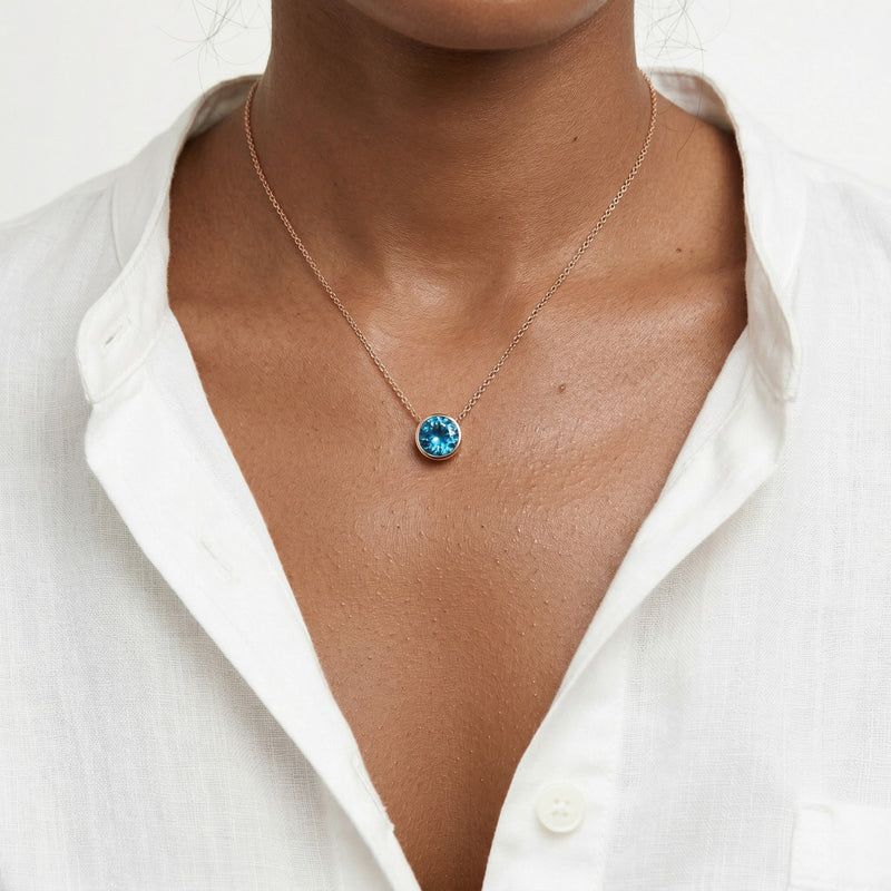 blue topaz birthstone necklace in rose gold finish — model view