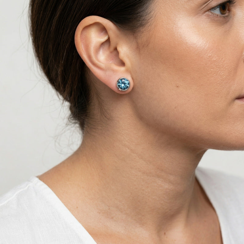 blue topaz birthstone stud earrings in white gold finish — model view
