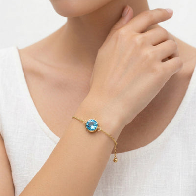 blue topaz birthstone bracelet in yellow gold finish — model view