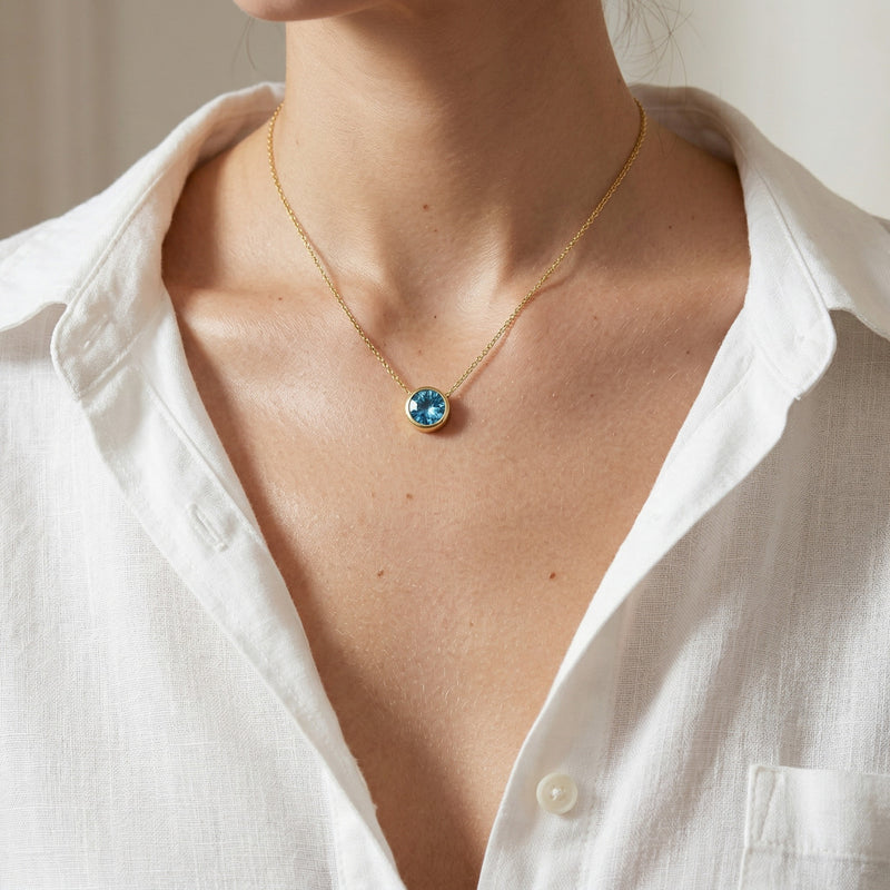 blue topaz birthstone necklace in yellow gold finish — model view