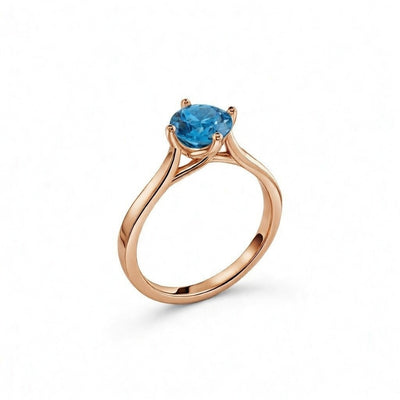 blue topaz birthstone ring in rose gold finish — side view
