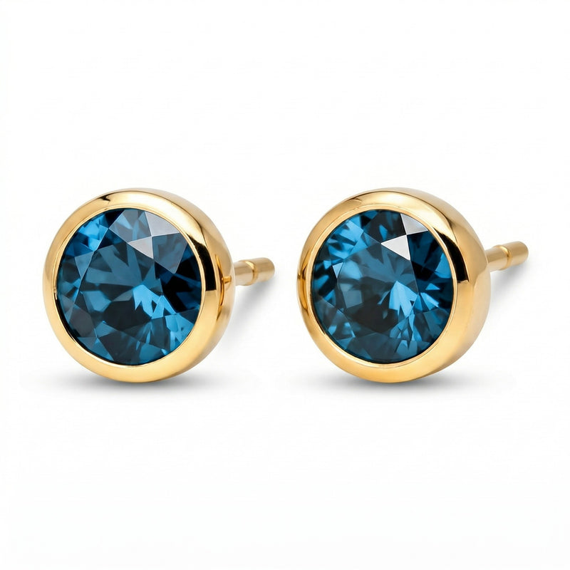 blue topaz birthstone stud earrings in yellow gold finish — side view
