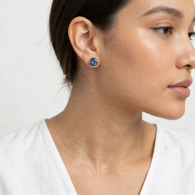 tanzanite birthstone stud earrings in yellow gold finish — model view