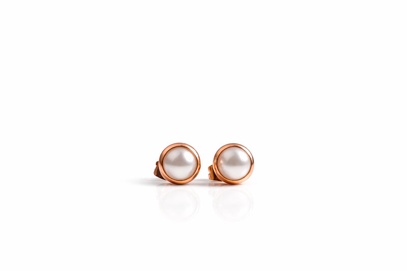 pearl birthstone stud earrings in rose gold finish — front view