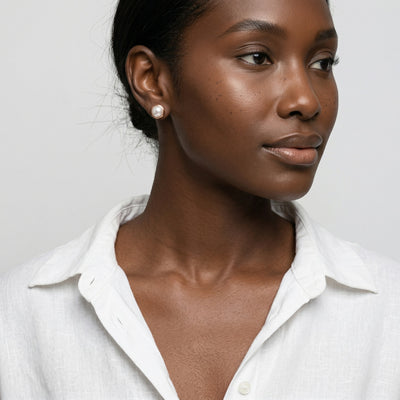 pearl birthstone stud earrings in rose gold finish — model view
