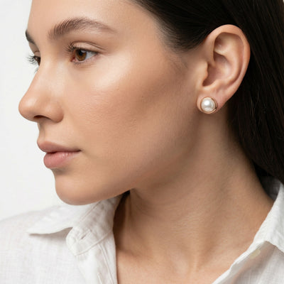 pearl birthstone stud earrings in rose gold finish — model view