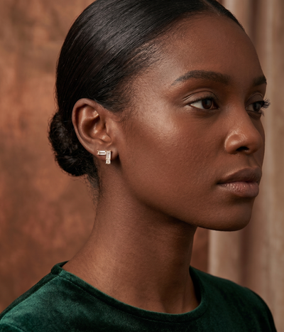 v shape baguette stud earrings in yellow gold finish — model view