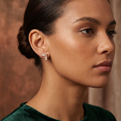 v shape baguette stud earrings in yellow gold finish — model view