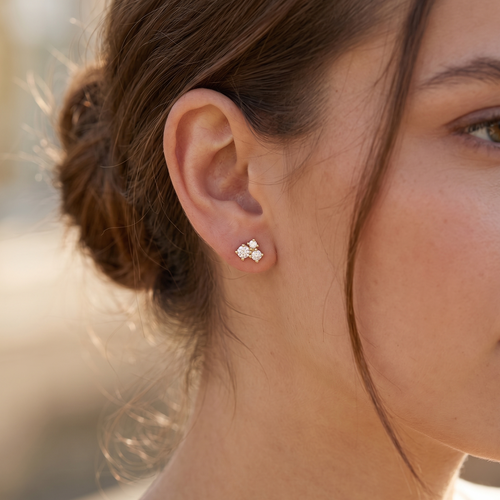 triple cluster stud earrings in yellow gold finish — model view