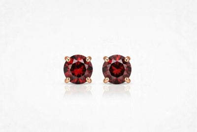 garnet birthstone stud earrings in rose gold finish — front view