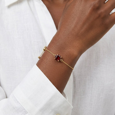 garnet birthstone bracelet in yellow gold finish — model view