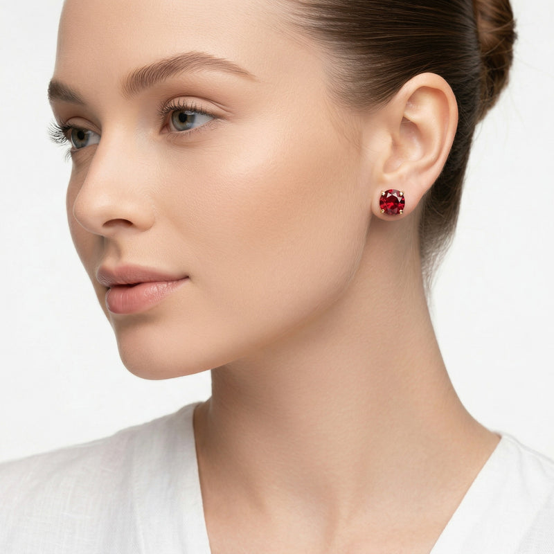 garnet birthstone stud earrings in yellow gold finish — model view