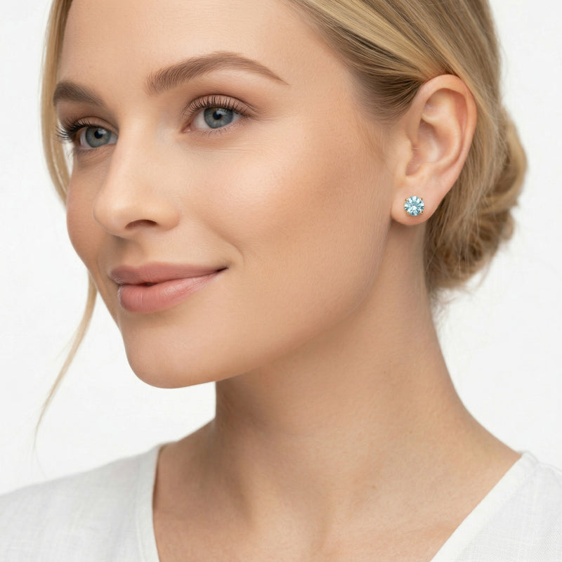 aquamarine birthstone stud earrings in yellow gold finish — model view