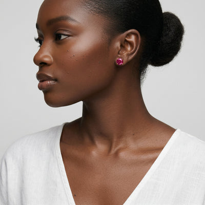 ruby birthstone stud earrings in rose gold finish — model view