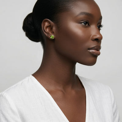peridot birthstone stud earrings in white gold finish — model view