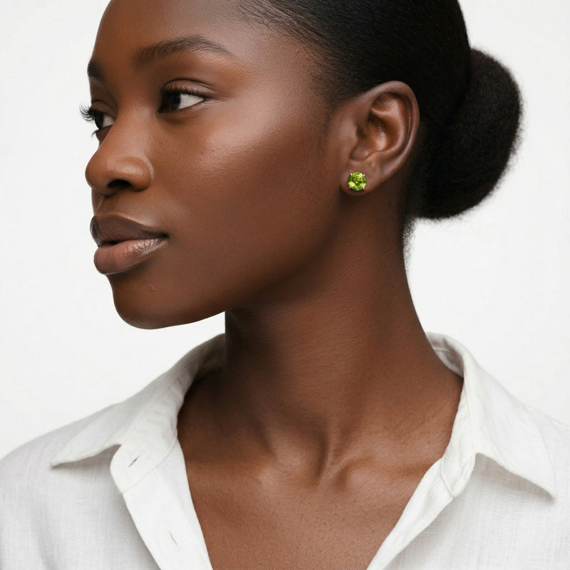 peridot birthstone stud earrings in yellow gold finish — model view