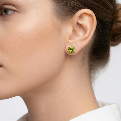 peridot birthstone stud earrings in rose gold finish — model view