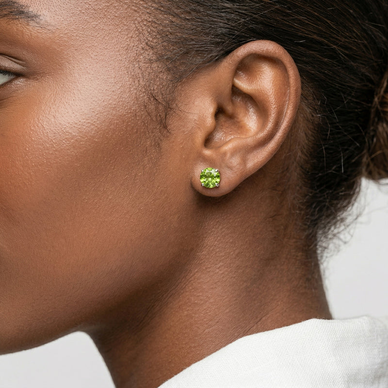 peridot birthstone stud earrings in white gold finish — model view