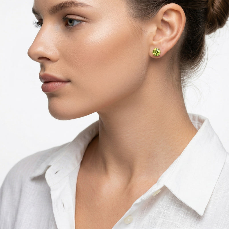 peridot birthstone stud earrings in yellow gold finish — model view