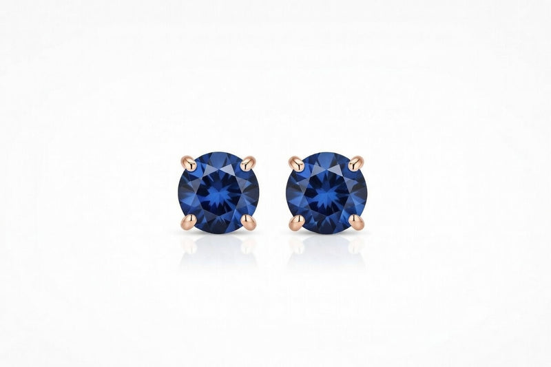 sapphire birthstone stud earrings in rose gold finish — front view