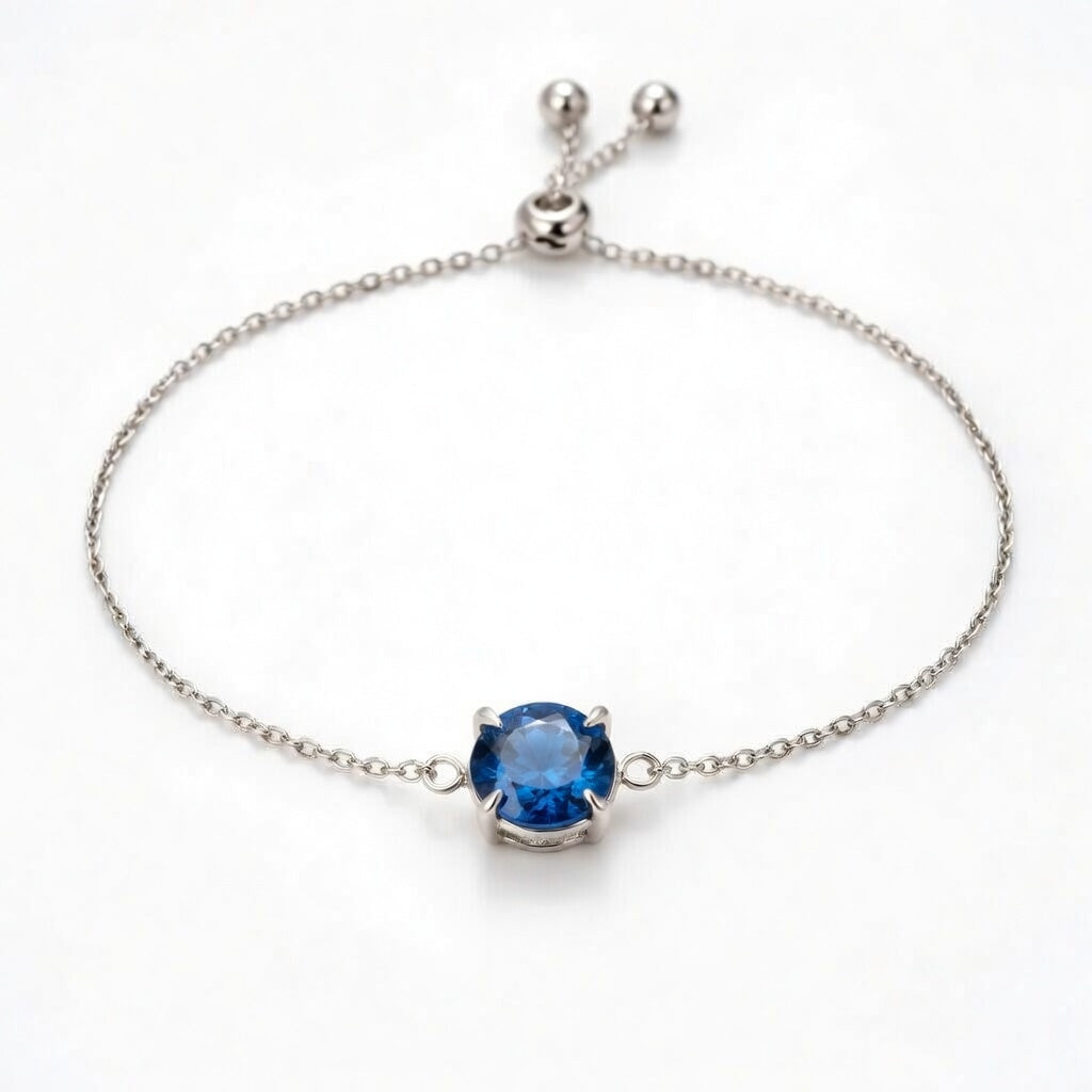 sapphire birthstone bracelet in white gold finish — front view