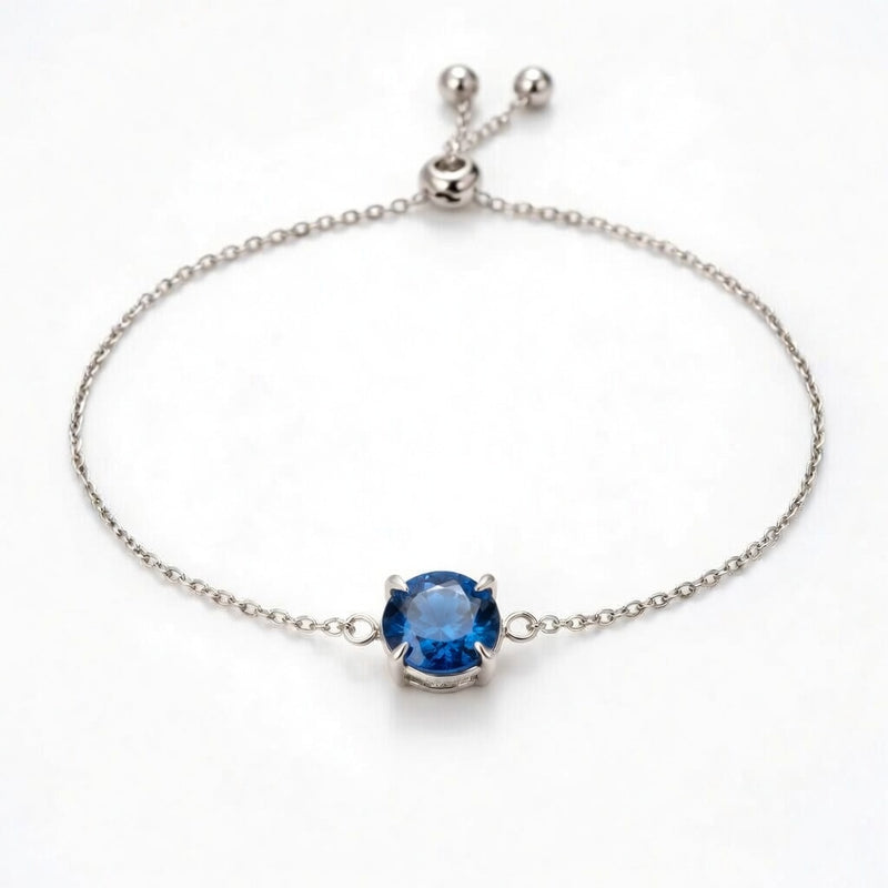 sapphire birthstone bracelet in white gold finish — front view
