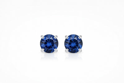 sapphire birthstone stud earrings in white gold finish — front view