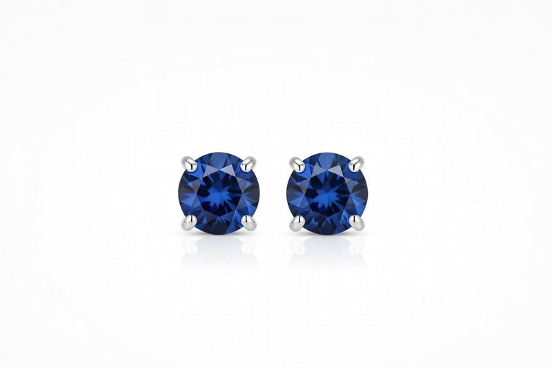 sapphire birthstone stud earrings in white gold finish — front view