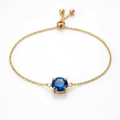 sapphire birthstone bracelet in yellow gold finish — front view