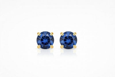 sapphire birthstone stud earrings in yellow gold finish — front view