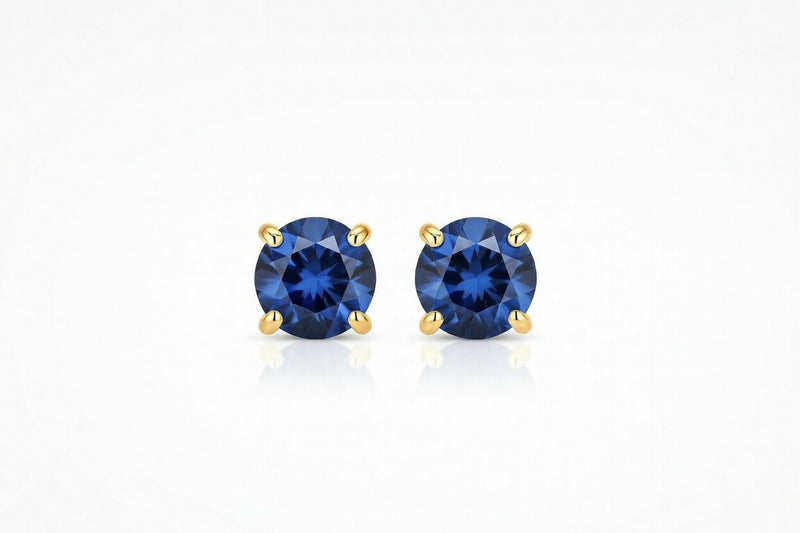 sapphire birthstone stud earrings in yellow gold finish — front view