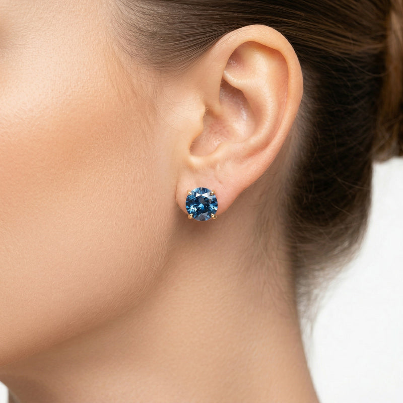 sapphire birthstone stud earrings in yellow gold finish — model view