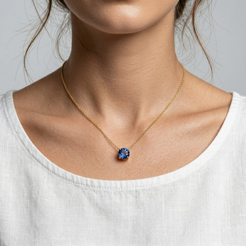 sapphire birthstone necklace in yellow gold finish — model view