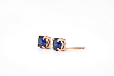 sapphire birthstone stud earrings in rose gold finish — side view